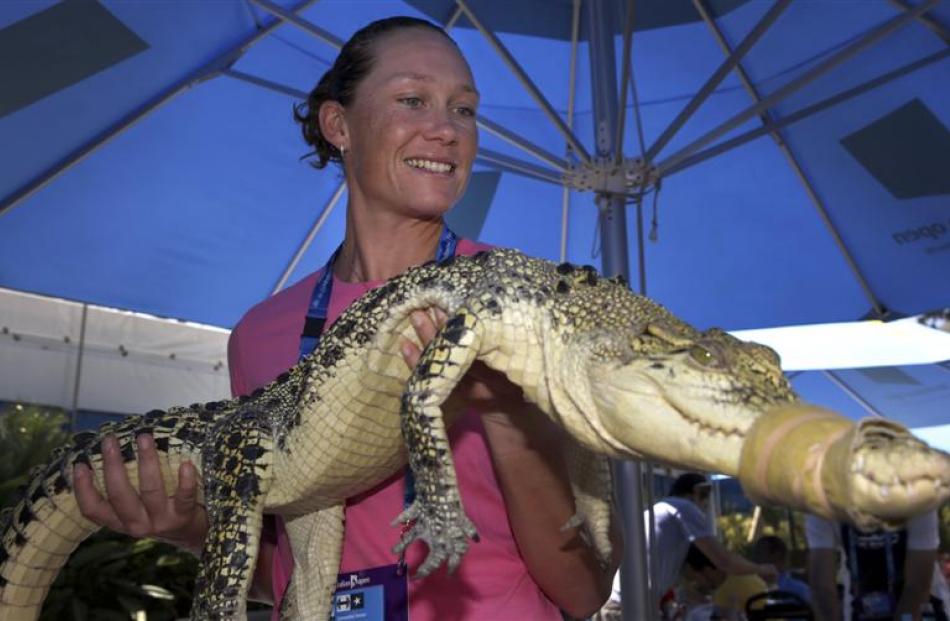 Australian Samantha Stosur holds Julius the crocodile.