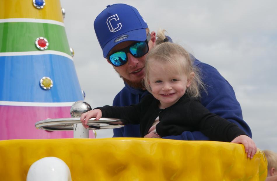 Josh and Ocean Knox (2), of Dunedin, enjoy the cup ride.