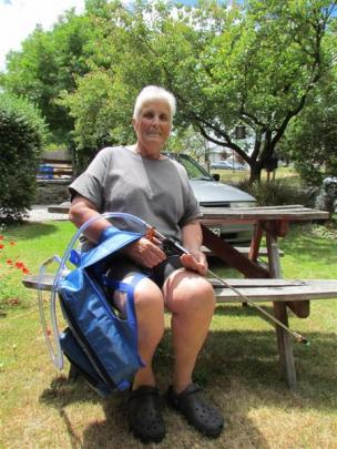 Wilding pines volunteer Fran O'Connor with one of the new basal barking backpacks with which ...