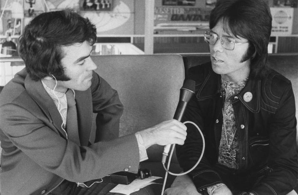 Jim Sullivan interviews pop star Cliff Richard at Dunedin Airport in 1977. Photo by Radio New...
