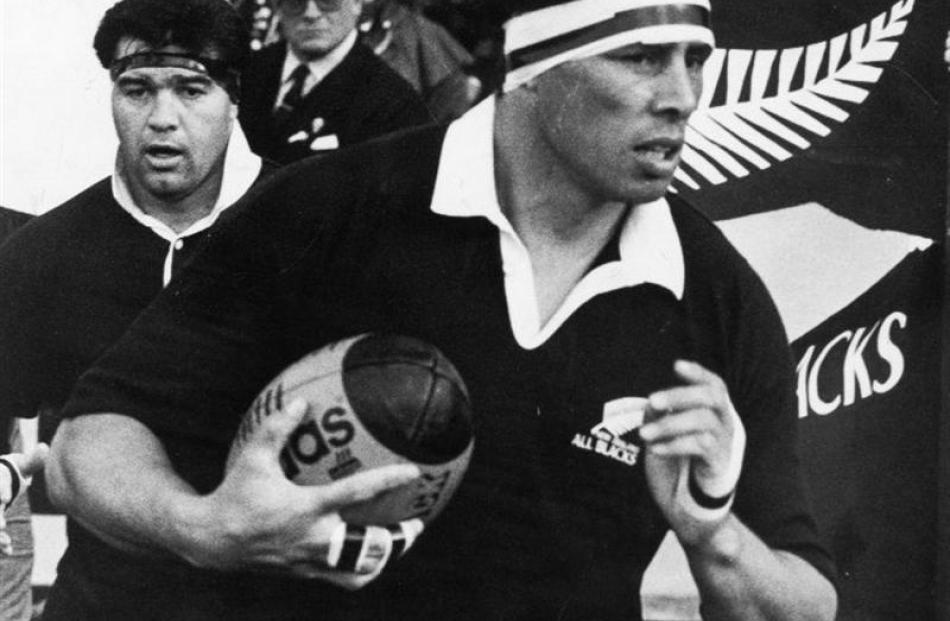 Buck Shelford leads out the All Blacks to play Scotland at Carisbrook in 1990. Behind him is prop...