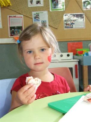 Jessie Glover (4) shows a freshly made heart-shaped sandwich.