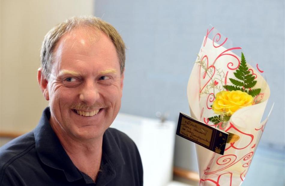 St John's staff member Tony Howard takes delivery of a rose for Valentine's Day  yesterday....