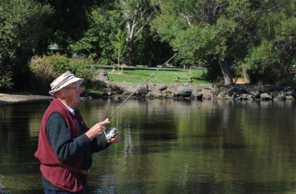 Bert Russell, of Waihola, catches a perch in the lake. Photos by Craig Baxter.