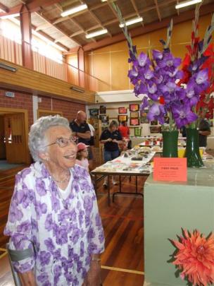 Cassie Weir, of Ranfurly, admires the flower entries at the Maniototo A&P Show yesterday.