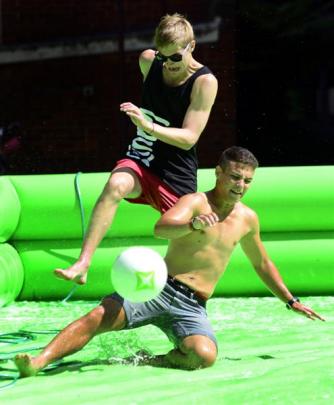 Students Michael Dassen (18, left) and Jawad Alatter (18) compete for the ball, while playing  ...