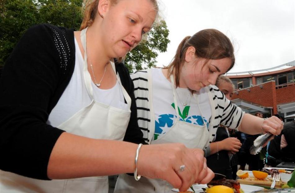 Preparing their dishes are Cecelia Hare (18, left) and Hannah Morton (19).