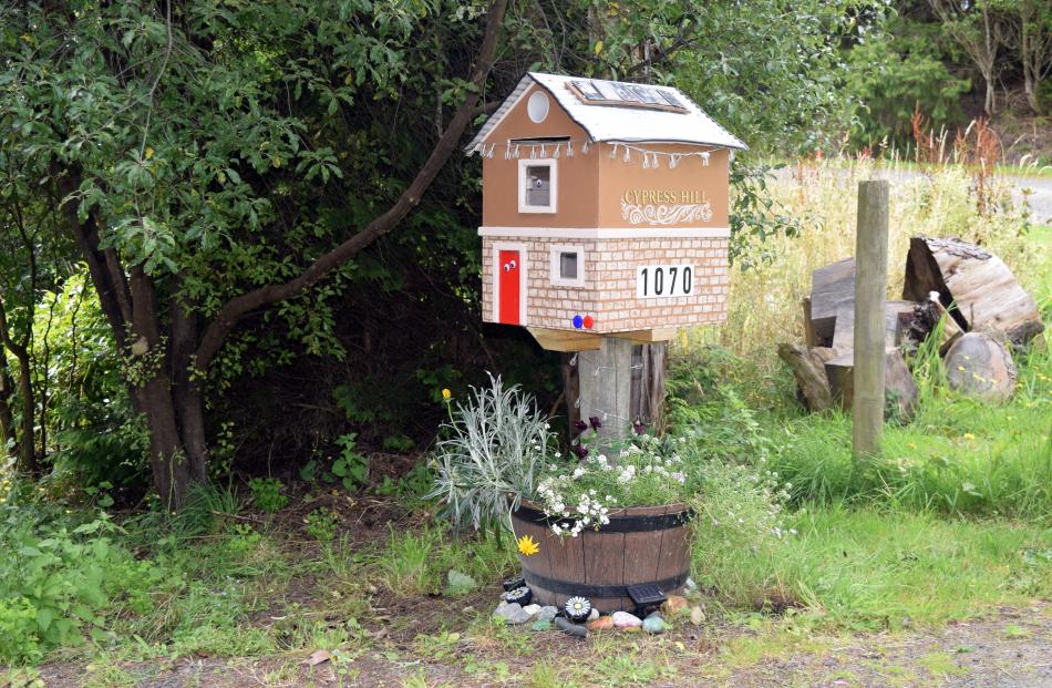 A two-storey mailbox house with solar panels on its roof near Waitati in Dunedin.