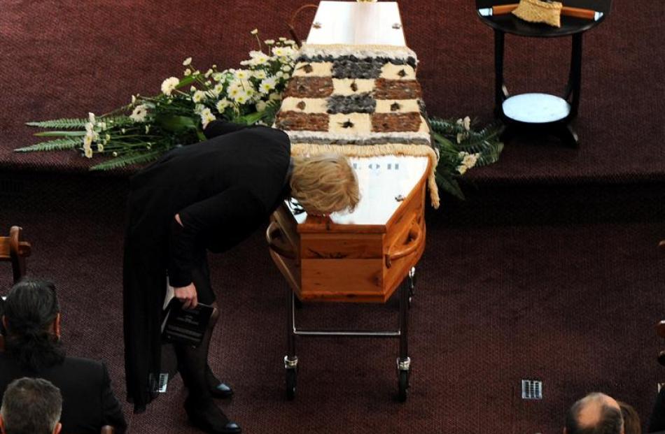 Hotere's daughter, Andrea Hotere-Naish, kisses the casket.  Photo by Craig Baxter.