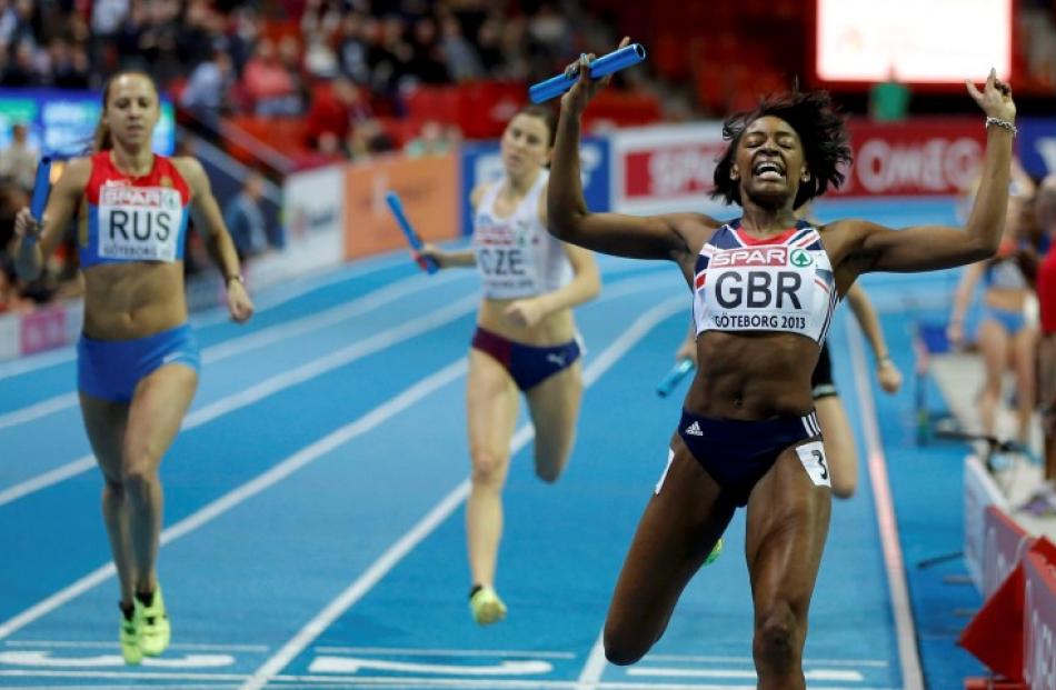 Perri Shakes-Drayton of Britain (R) celebrates her team's victory in the women's 4x400m relay....