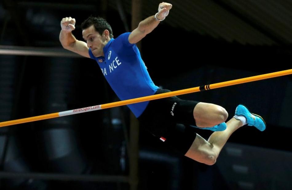 Renaud Lavillenie of France in the men's pole vault final. REUTERS/Phil Noble