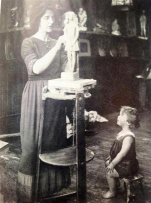 Kathleen Scott at work in her studio, watched by her son Peter.
