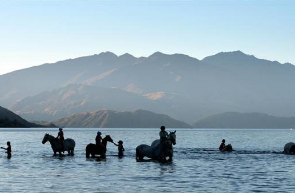 Children wallow in Lake Wanaka on their horses after the Upper Clutha A&P Show on Saturday...