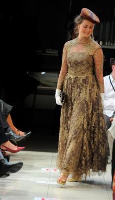 Kiri Spain, of Dunedin, wears a gold and brown lace dress given to the  collection by a Sydney...