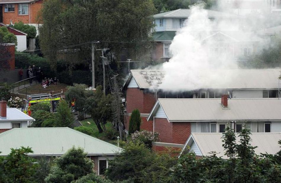 Smoke billows from a flat on Glen Rd yesterday. Photo by Craig Baxter.