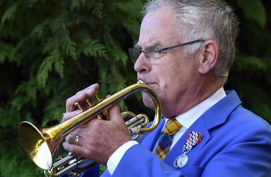 Philip Craigie plays during the service at Memorial Park in Green Island. PHOTO: PETER MCINTOSH