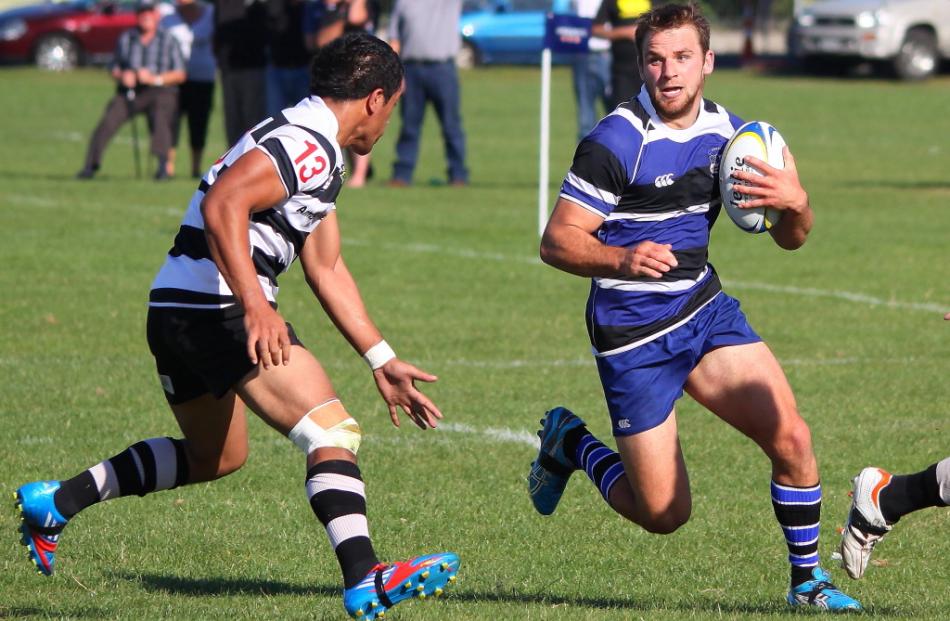 Opposites, Apelu Alapati (Southern No 13) and Jayden Spence (with ball) size each other up in the...