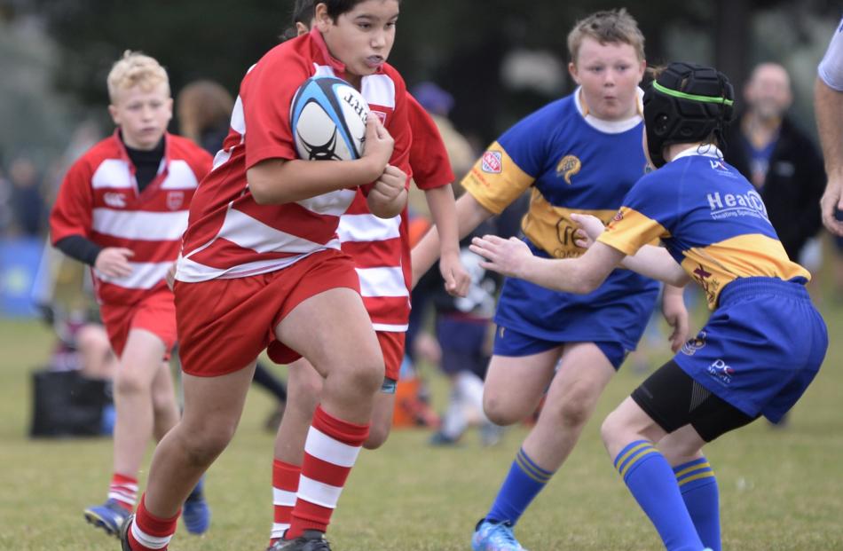 Kaian Holgate (10), from the Balclutha Under-11s charges up the field.