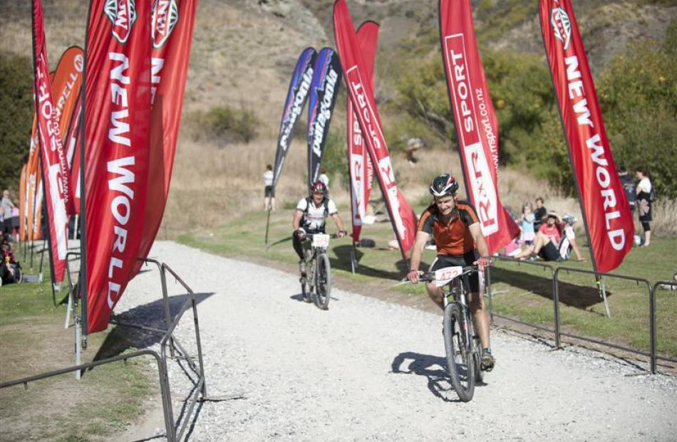 ohn Coburn, of Queenstown, crosses the finish line at Chard Farm on Saturday morning.
