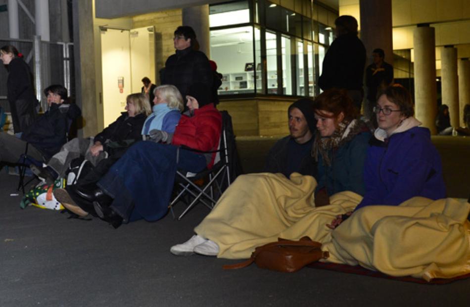 Fans listen from outside the stadium.