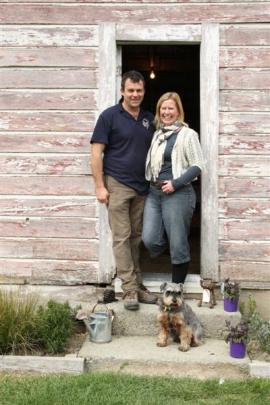 Steve and Heather Wilkins outside their 101-year-old woolshed at Athol from which they sell...