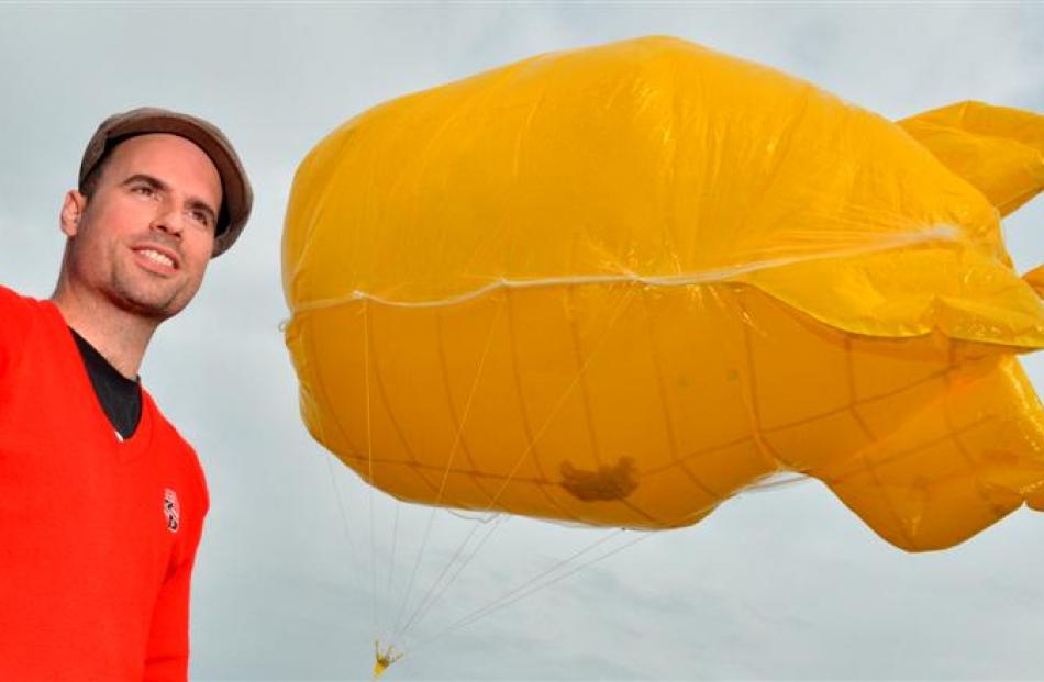 Artist Shane McGrath prepares the balloon in Wharf St, Dunedin, yesterday morning. Photos by...