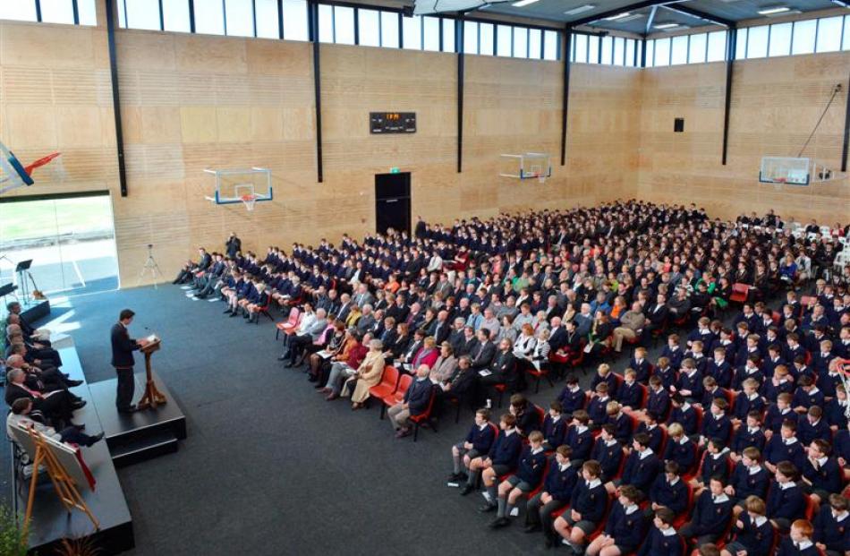 John McGlashan College head boy Ed Davies speaks  to a packed assembly of pupils, old boys and...