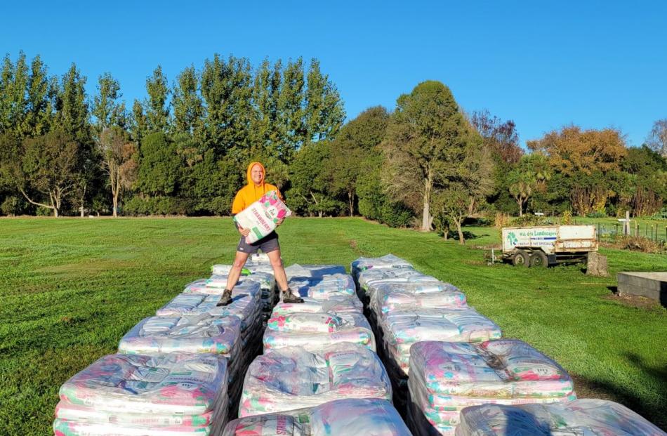 Andrew Lysons-Smith from Tui Garden Products helped unload the bags of compost. PHOTO: SUPPLIED
