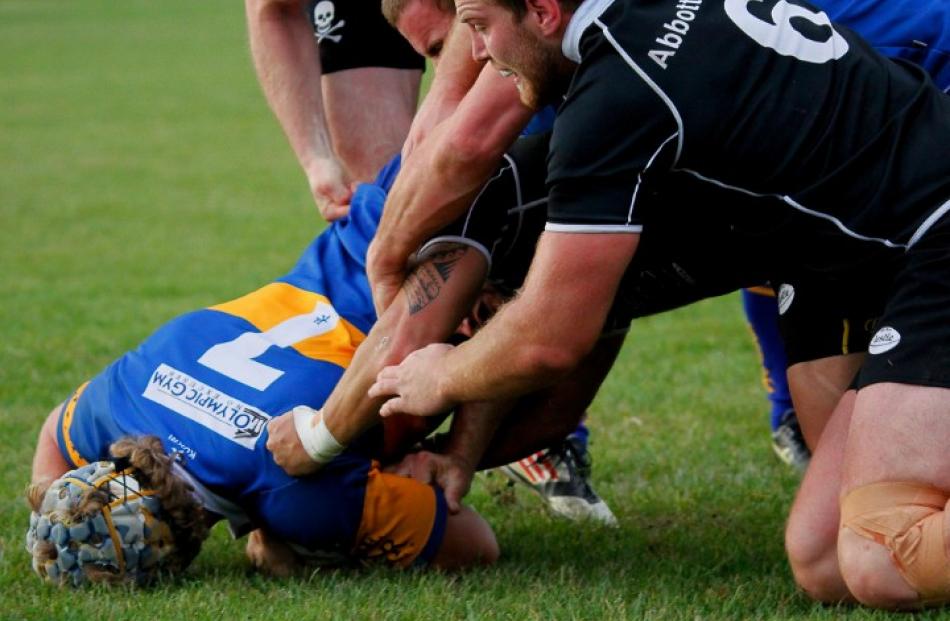 Taieri flanker Willis Scott powers his way through four Pirates defenders to score.