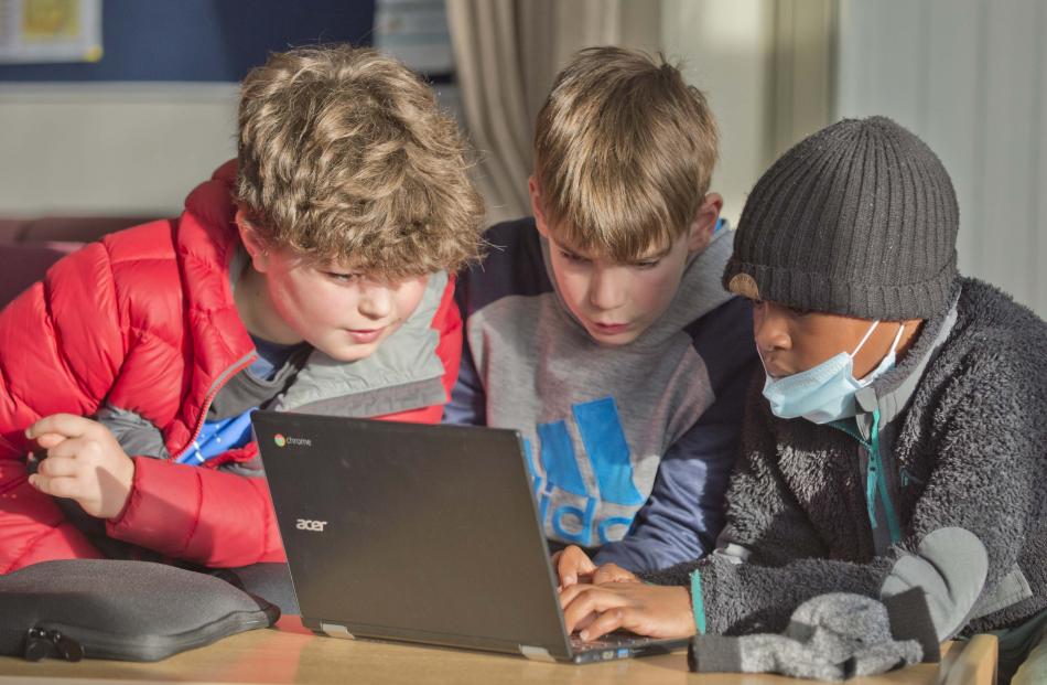 Henry Schonthal (left, 9), Tarn Elder (10) and Tomide Adebowle (9) compete during the quiz.