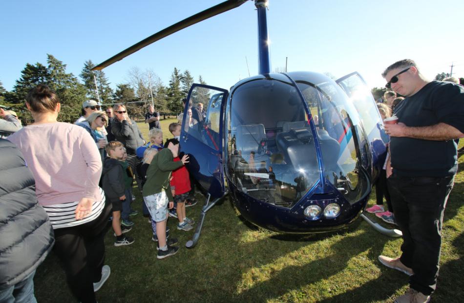 Crowds at the Fernside School fundraiser get a look at the Robinson R44 helicopter. PHOTO: JOHN...