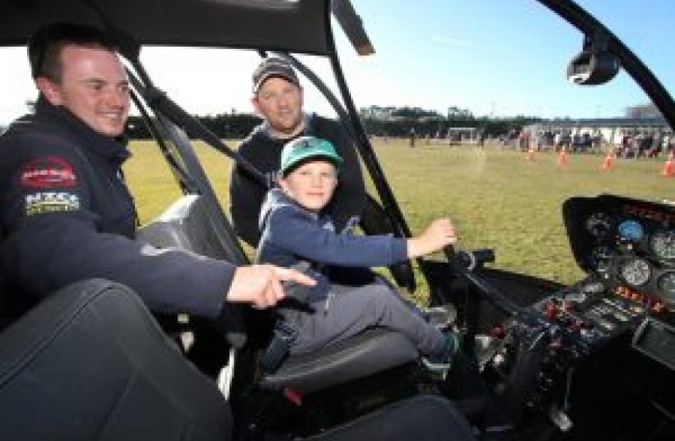 Fernside School pupil Kellan Crawford, 8, learns about flying a helicopter with pilot Matt Shaw ...