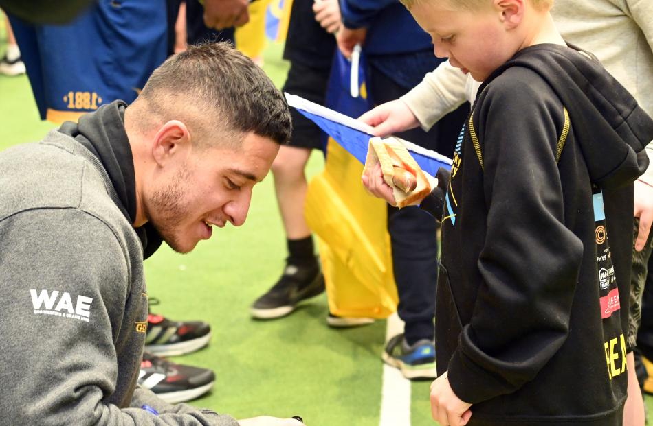 Frank Cayford (7), of Dunedin, has his Otago flag signed by winger Freedom Vahaakolo.