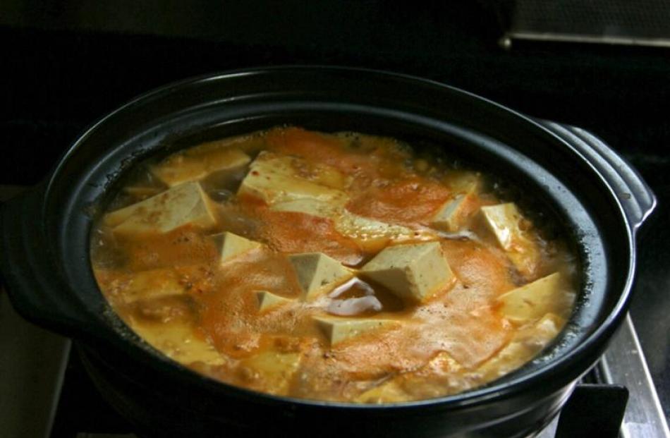 Tofu soup bubbling away on the stove.