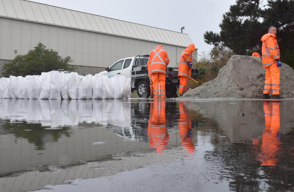 Delta workers fill a stockpile of sandbags in the carpark next to the Dunedin Ice Stadium on...
