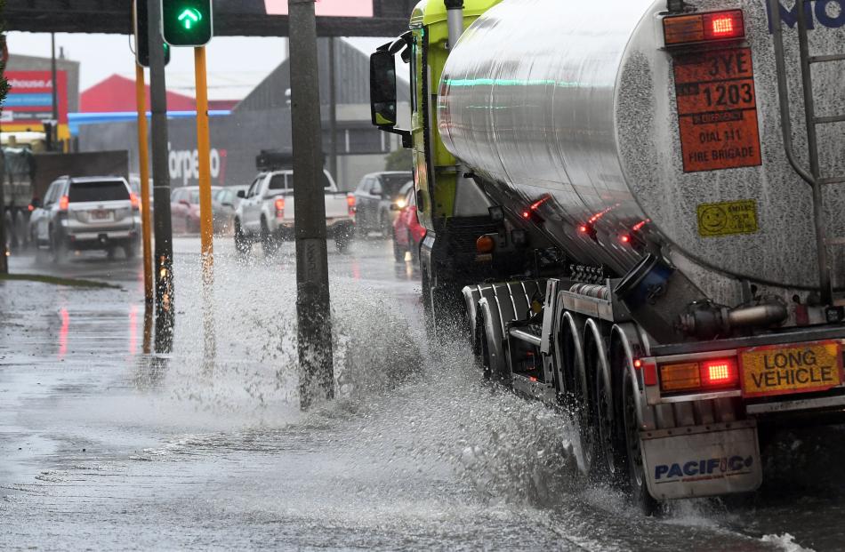 A tanker pushes through surface water on Andersons Bay Rd. PHOTO: STEPHEN JAQUIERY