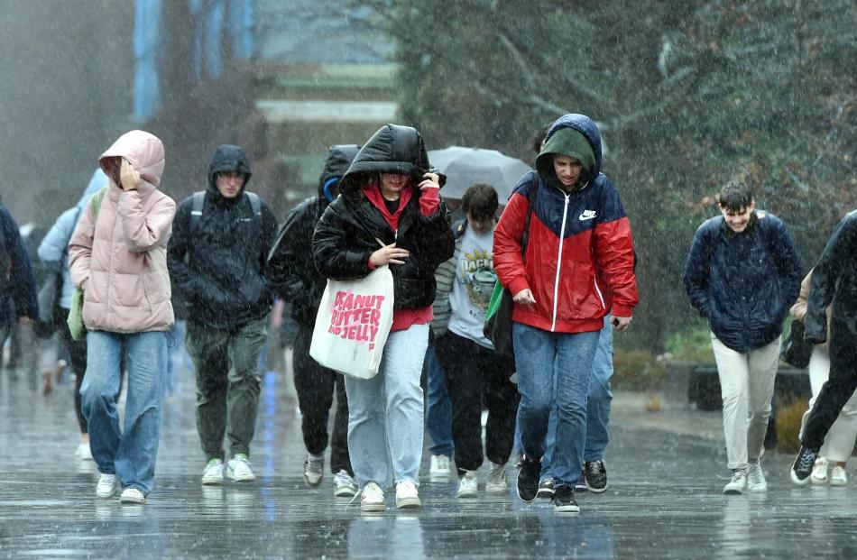 Students soaked by heavy rain between classes at the Otago University on Tuesday. PHOTO:PETER...