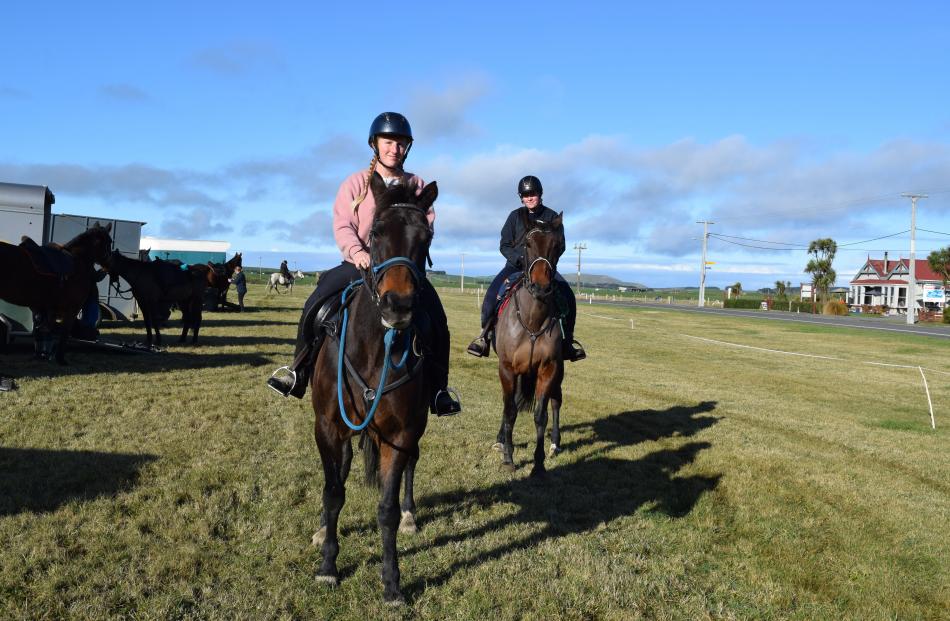 Helenna Charlson (left), of Balfour, rides horse Sarita and Sam Roberts, of Lumsden, rides Eddie,...