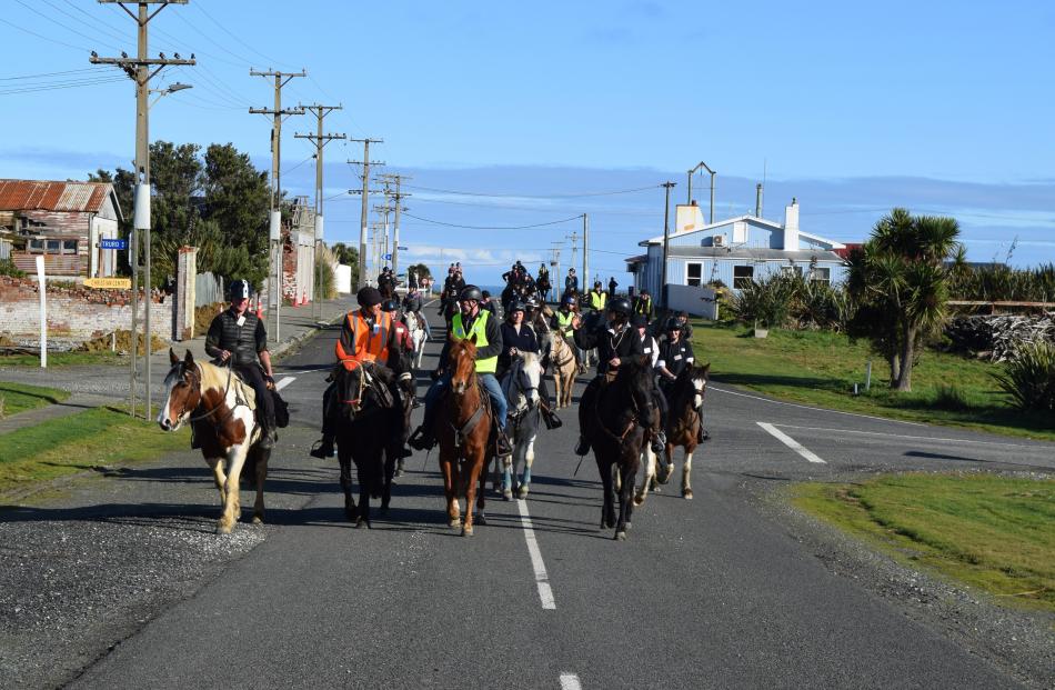 A team of horses are ridden in a street in Orepuki during a Wairio Hack Club fundraising event in...
