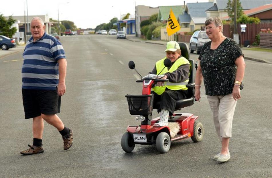 Alan and his parents, Ian and Val, walk the quiet streets of Invercargill.