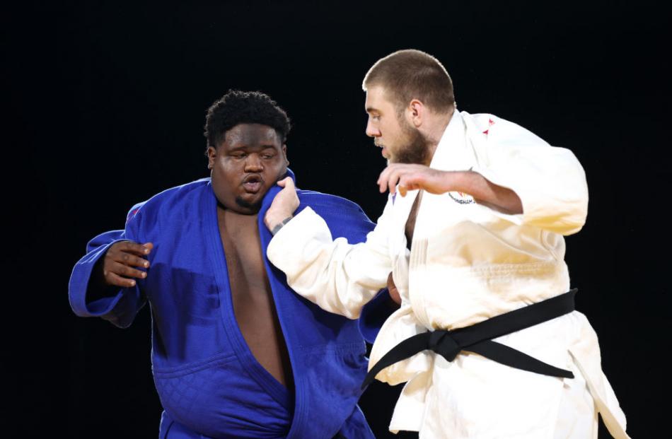 Kody Andrews (right) tussles with Sebastian Perrinne (Mauritius) during the 100kg-plus judo...