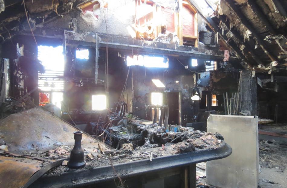 The roof was on fire . . . Daylight peeks through the ripped open roof, back towards the entrance.
