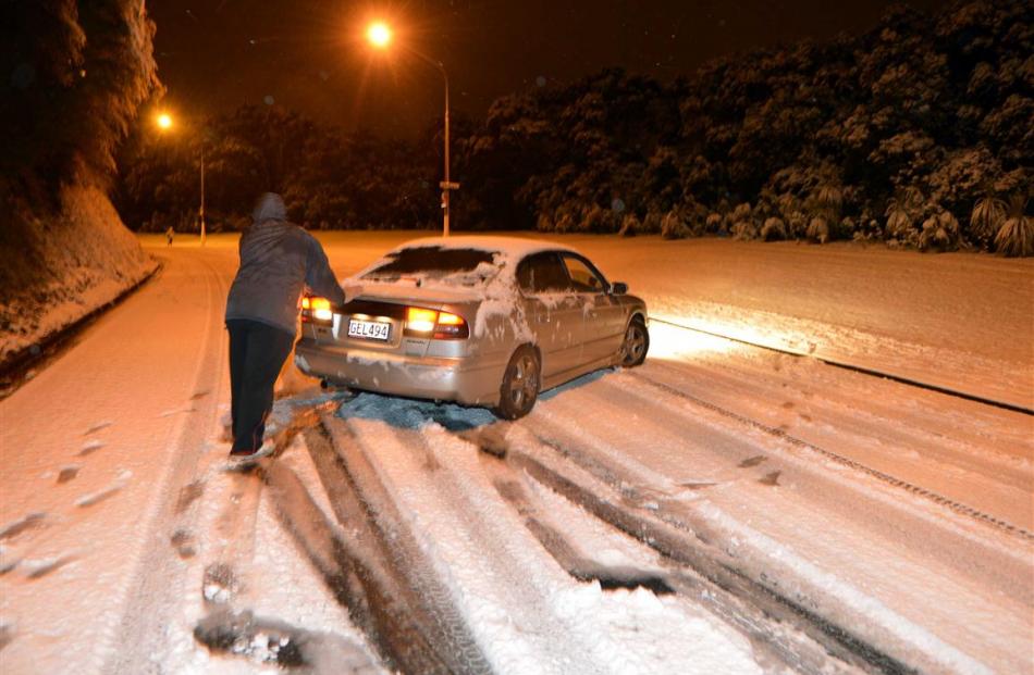 A passenger helps a motorist on Drivers Road do a U turn. Photo by Stephen Jaquiery