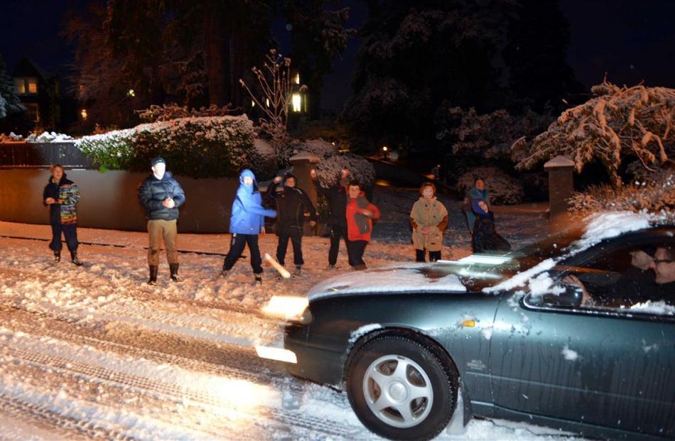 Take that . . . Boarders at OBHS giver motorists a snowy welcome as they negotiate Highgate....