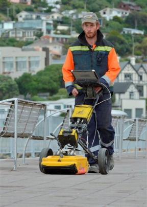 Grant Samuel, from KB Contractors, uses a ground-penetrating radar to measure the integrity of...