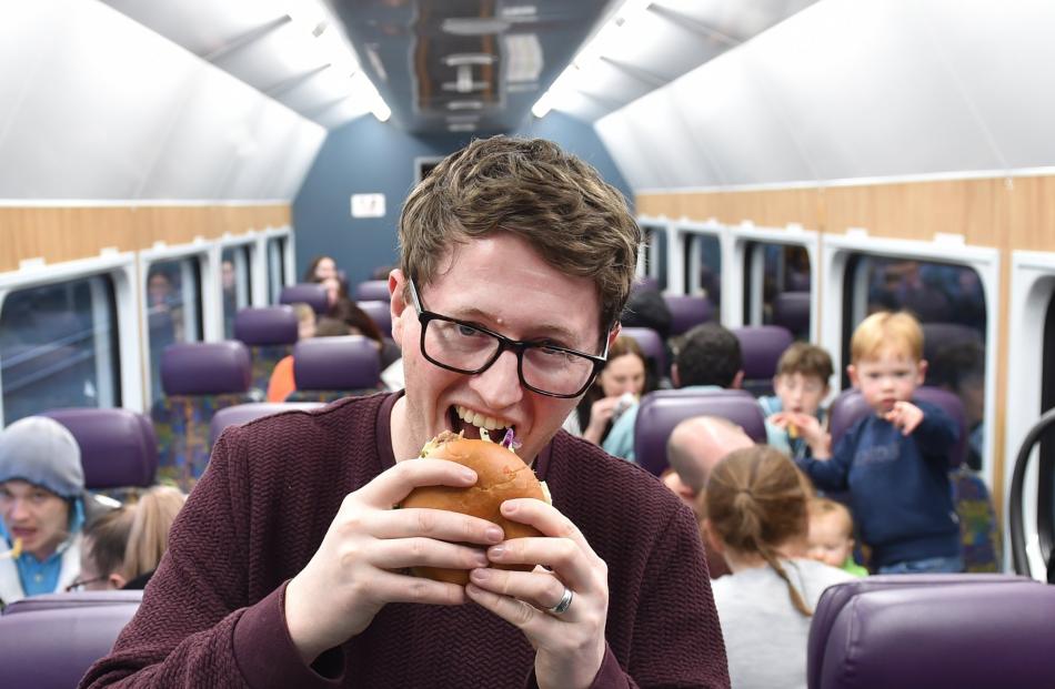 Matthew Flatt, of Dunedin, tucks into his burger at Dining On The Tracks at the Dunedin Railway...