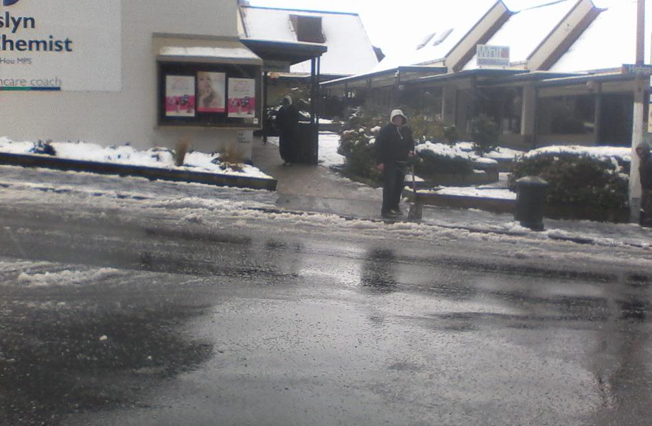 Roslyn New World manager Chris Acklin shovels snow. Reader photo by Suzy