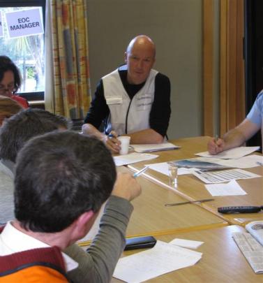 Queenstown Lakes District Council emergency management officer Jon Mitchell is briefed during the...