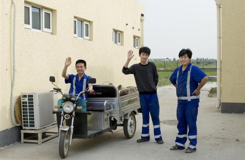 Workers on Fonterra's Yutian 2 dairy farm pose for the camera.