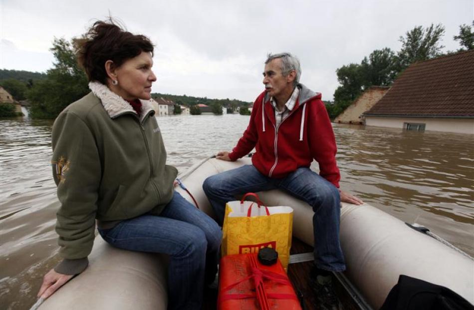 Residents observe their flooded village of Kresice near the city of Litomerice, in the Czech...